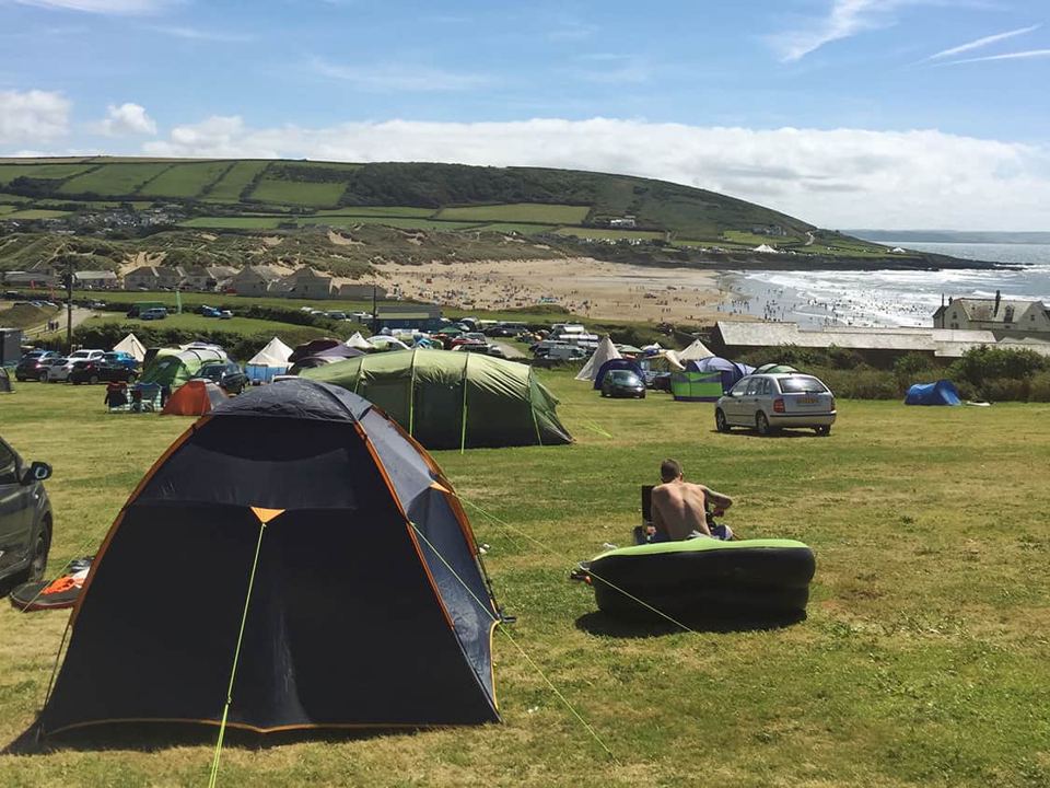 Tents on the field with the bay