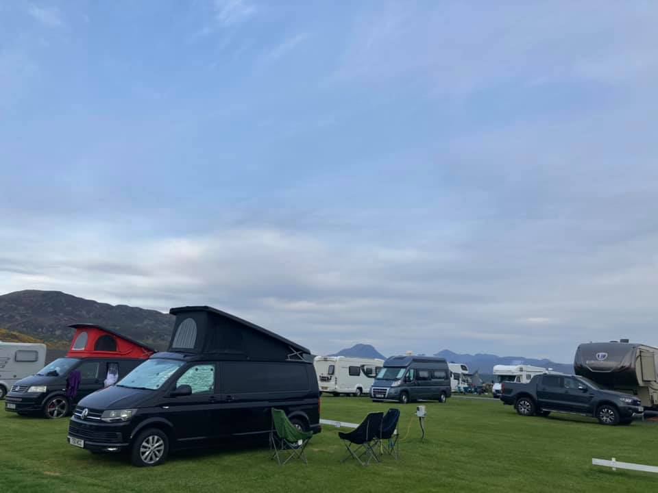 Campervans on the grass with hills