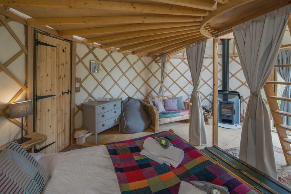 Yurt with woodburner and sofa