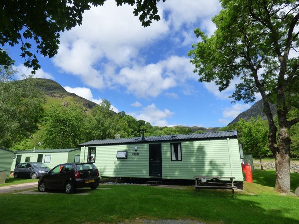 Static caravan beside the trees