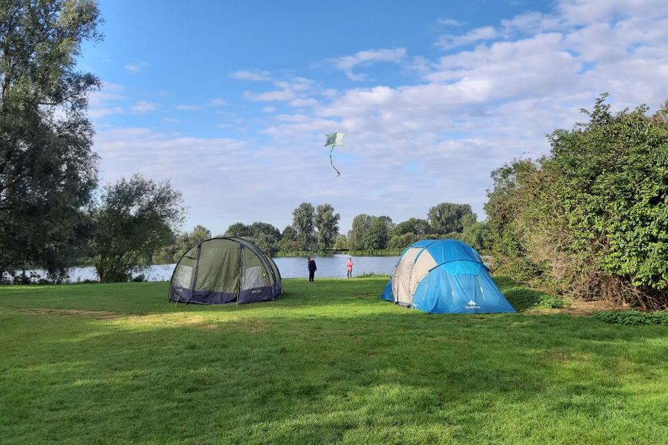 Tents on grass by the water