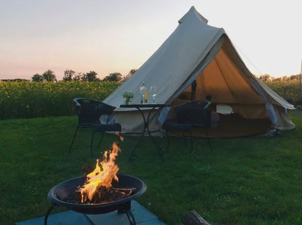 Bell tent and fire pit at dusk