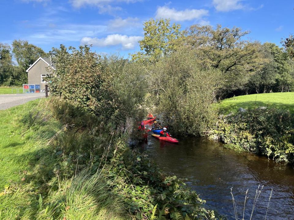 Kayakers on the river by the site