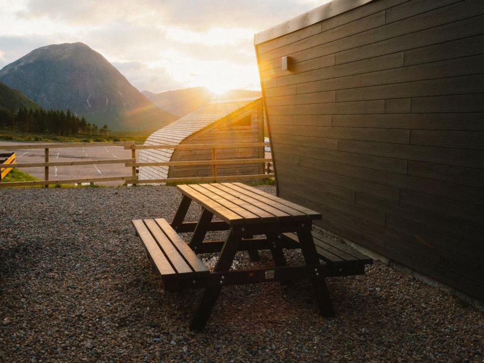 Lodge and picnic table with mountain view