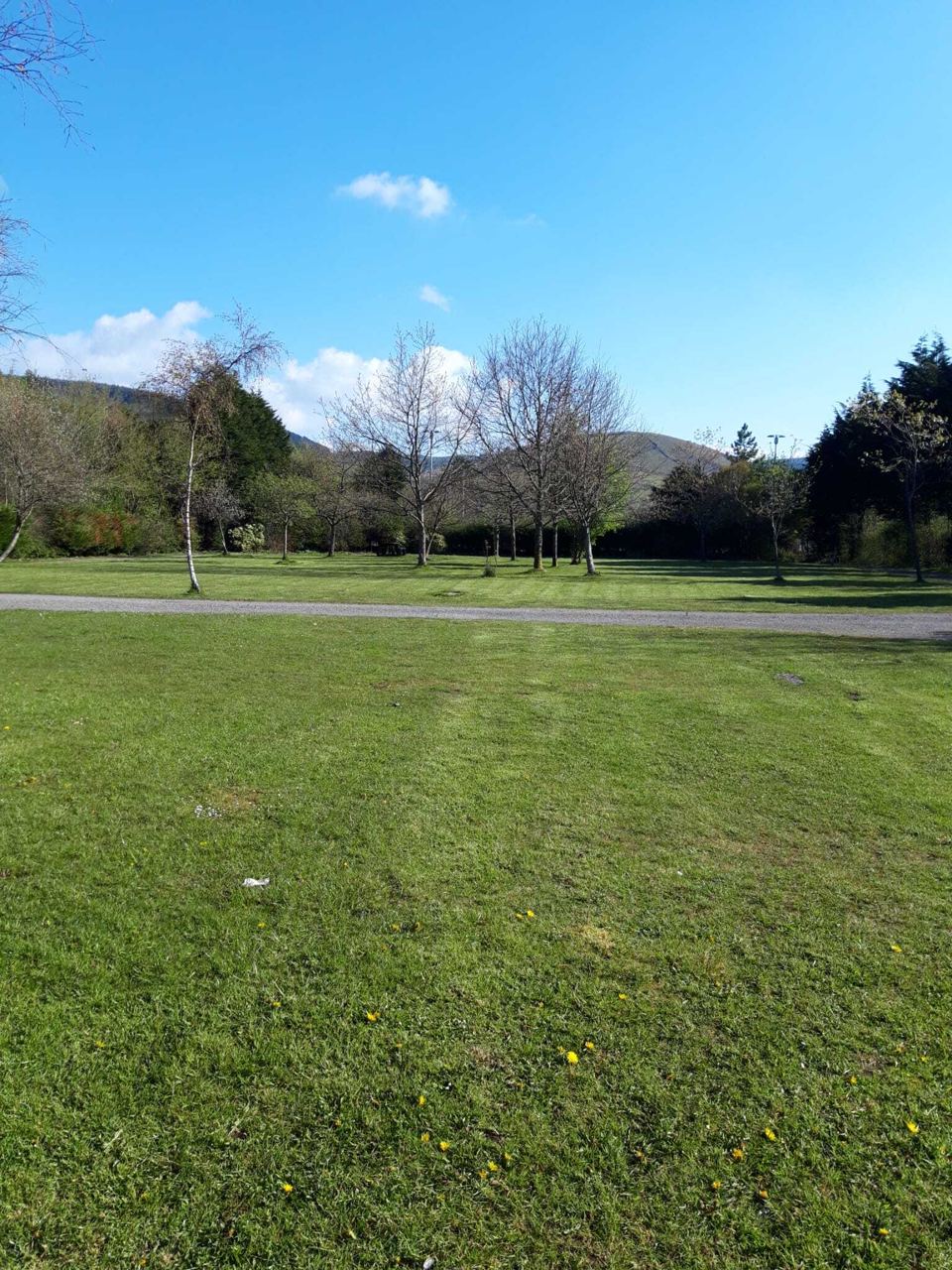 Grass pitches with hills behind