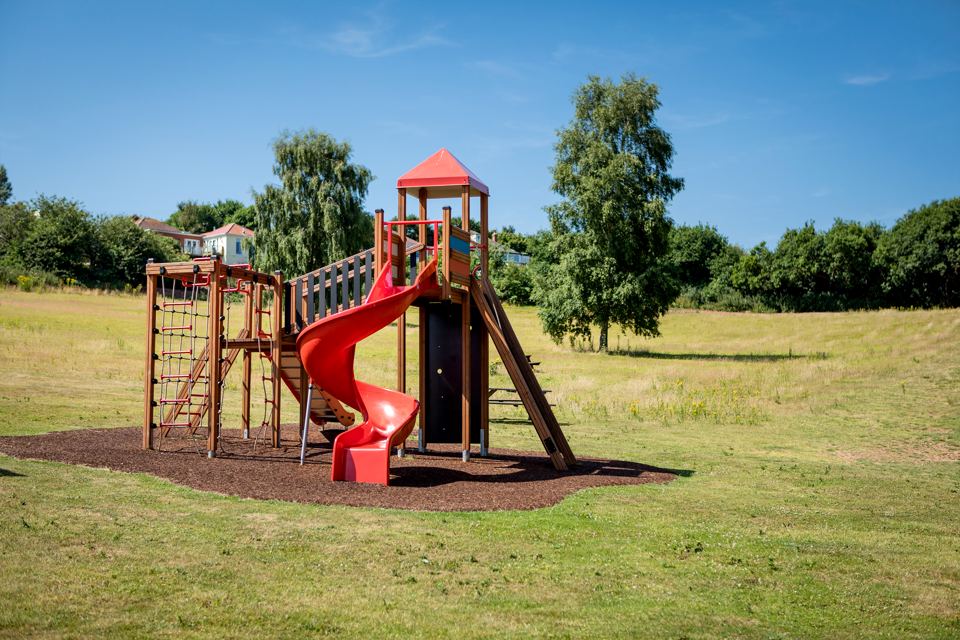 Play area with slide and climbing frame