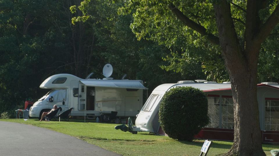 Motorhome and caravan under trees