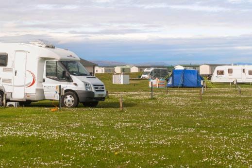 Touring field with motorhome and tent