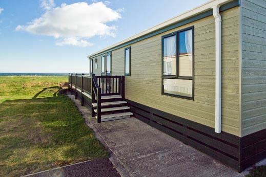 Green-clad caravan by the field