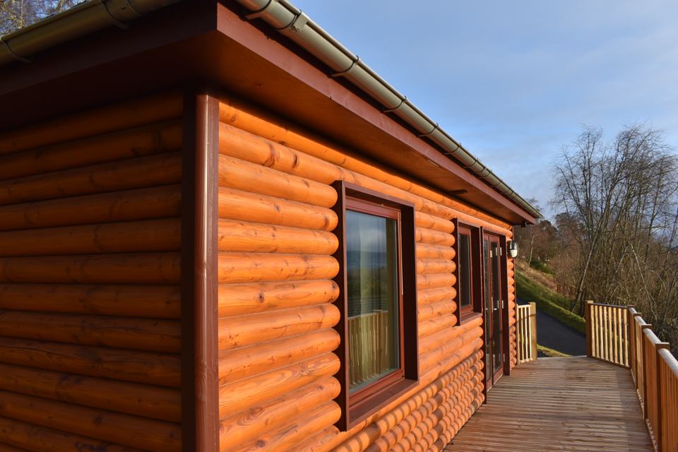 Log-clad lodge with decking