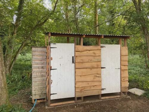 Wooden shower huts in the wood