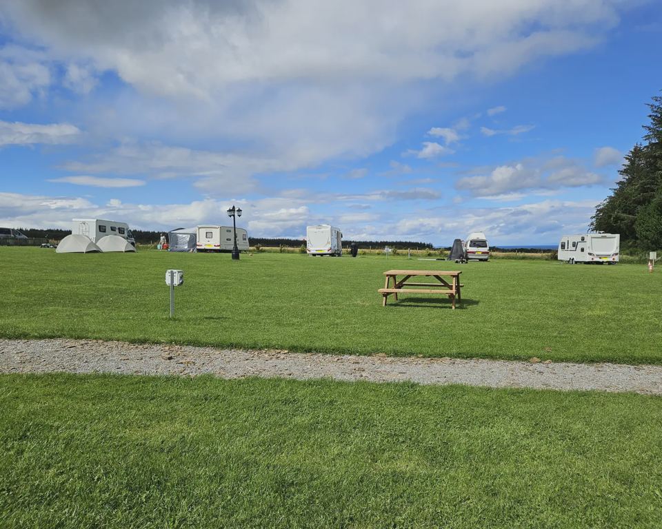 Touring field with sea beyond