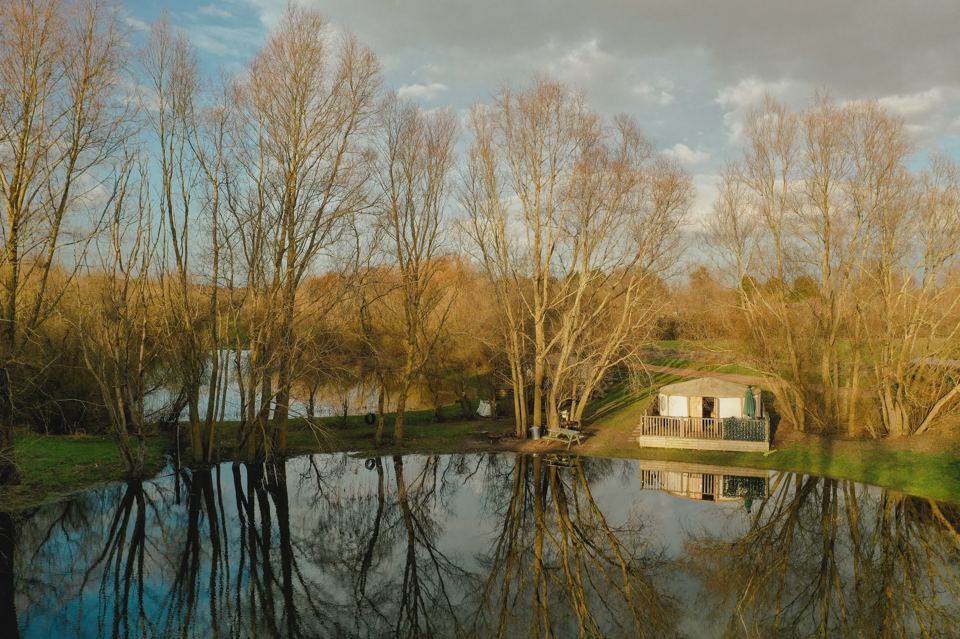 Pond with a cabin beyond
