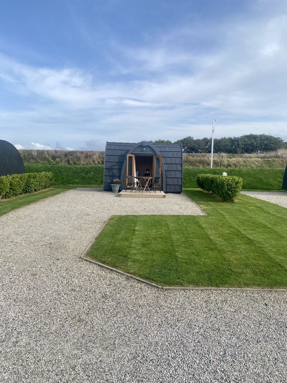 Pod on its own gravel and lawn pitch