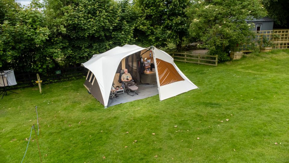 Tent with awning on grass