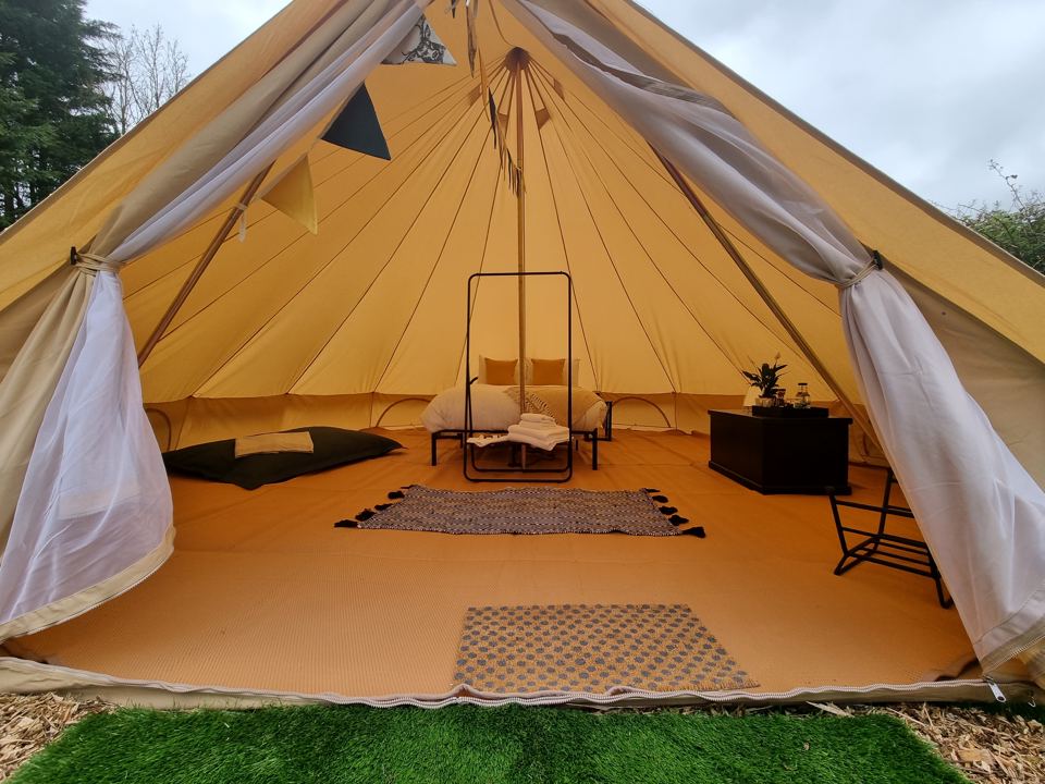 Bell tent interior with rug and chairs