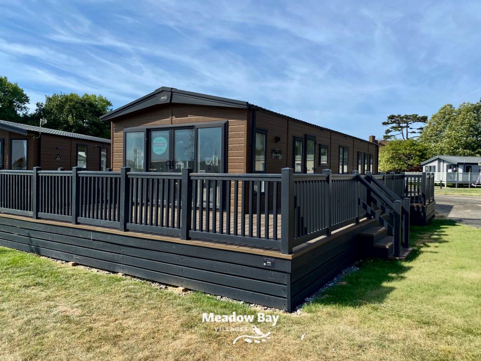 Lakeside caravan with dark decking