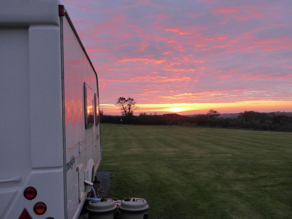 Sunset beside a caravan