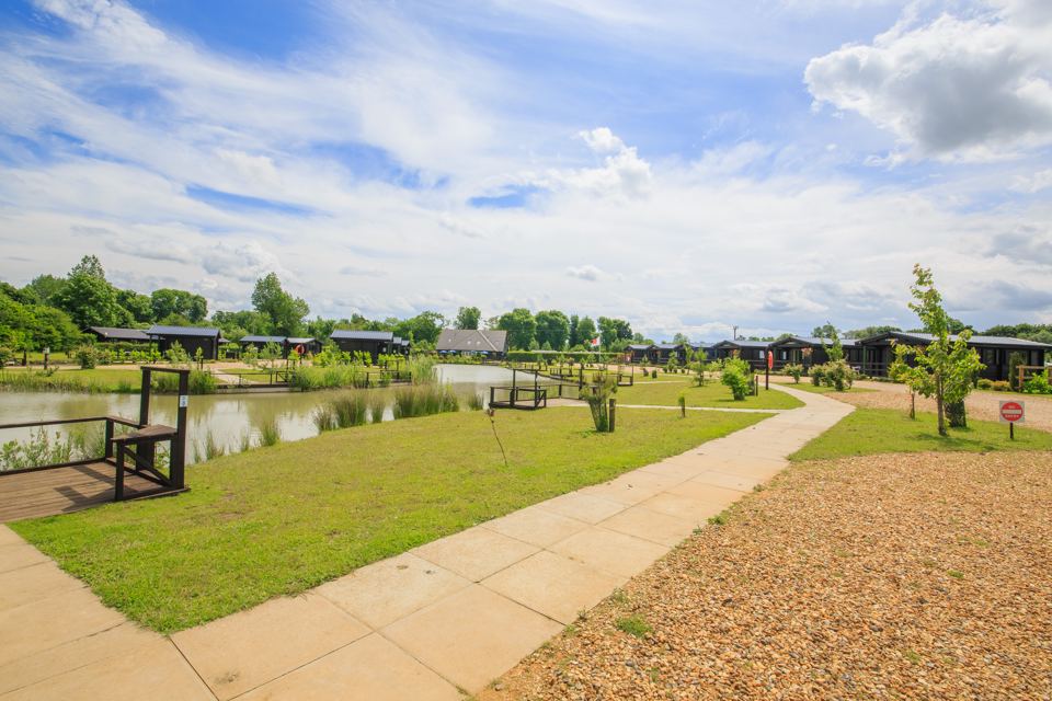 Path beside the lake and cabins