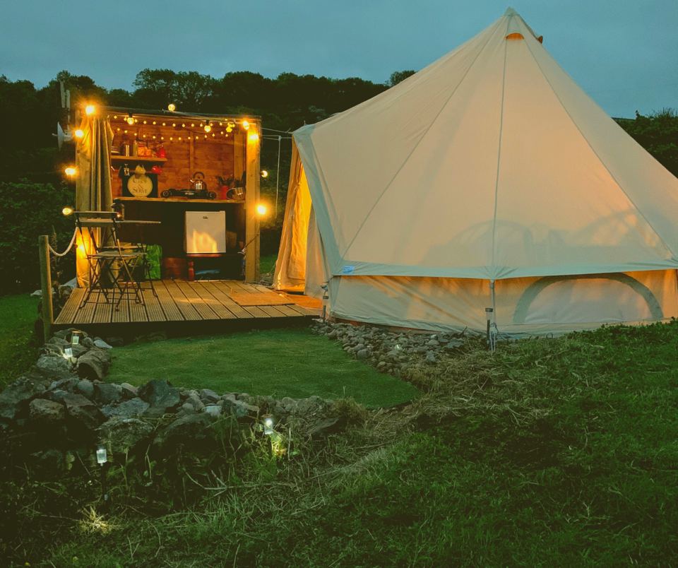 Bell tent lit up at dusk