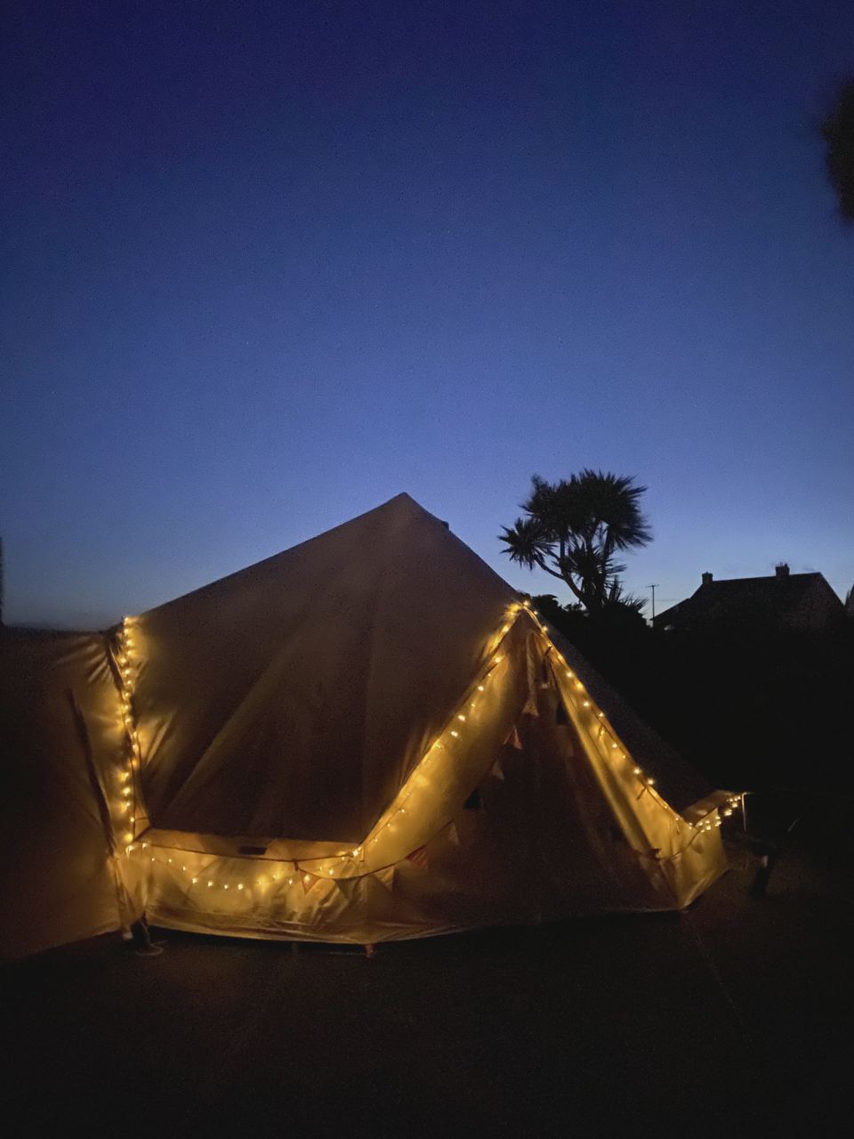 Tent with fairy lights at dusk