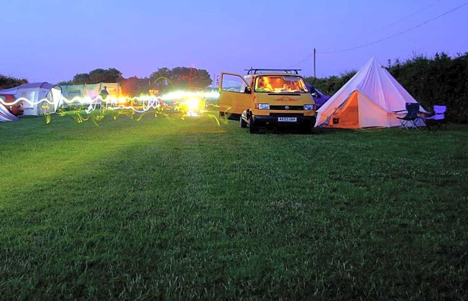 Campervan and bell tent at dusk