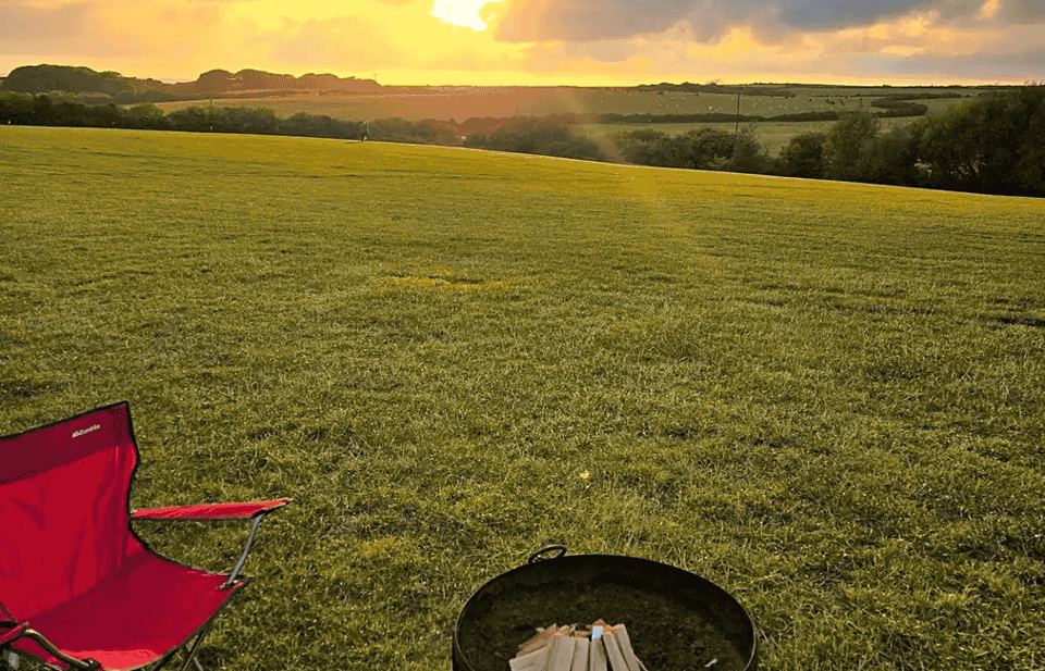 Field and fire pit at sunset