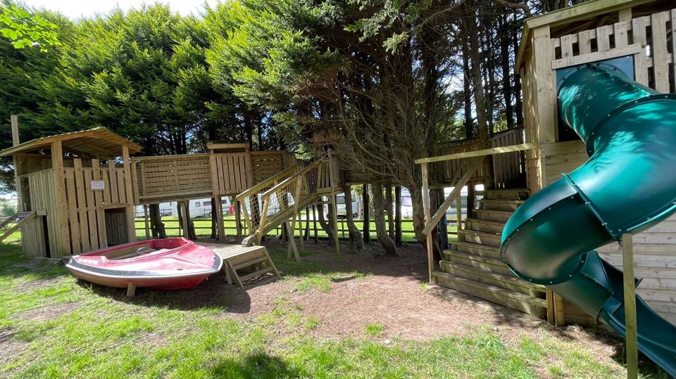 Play area with slide and climbing frame