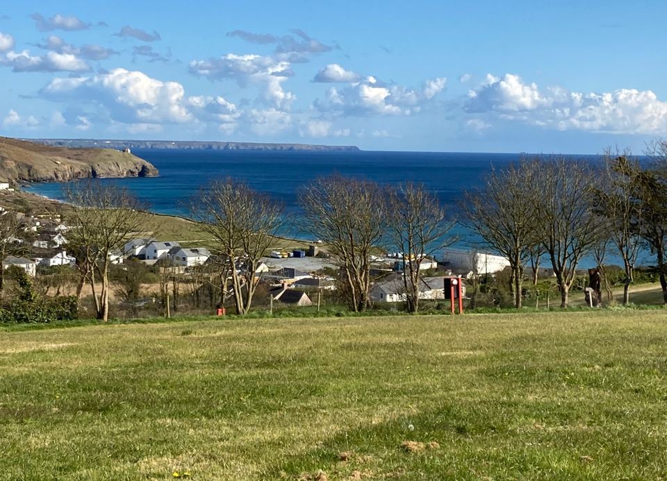 Caravans on the slope with the sea beyond