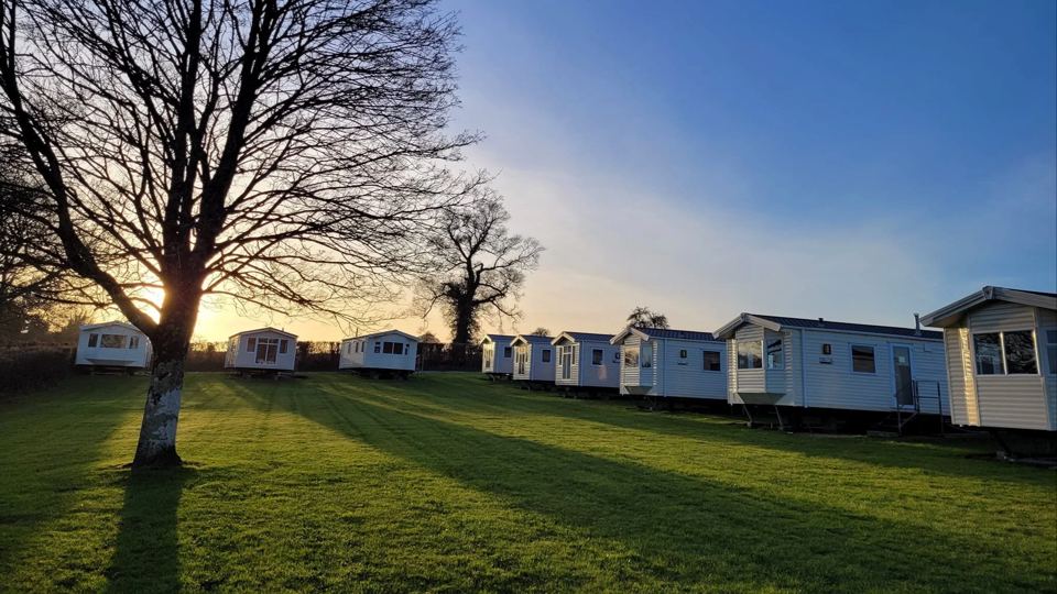 Caravans on the lawn at sunset