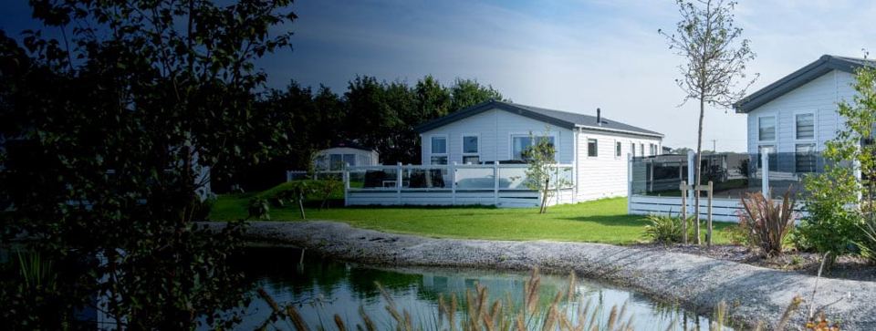 Holiday homes beside a pond