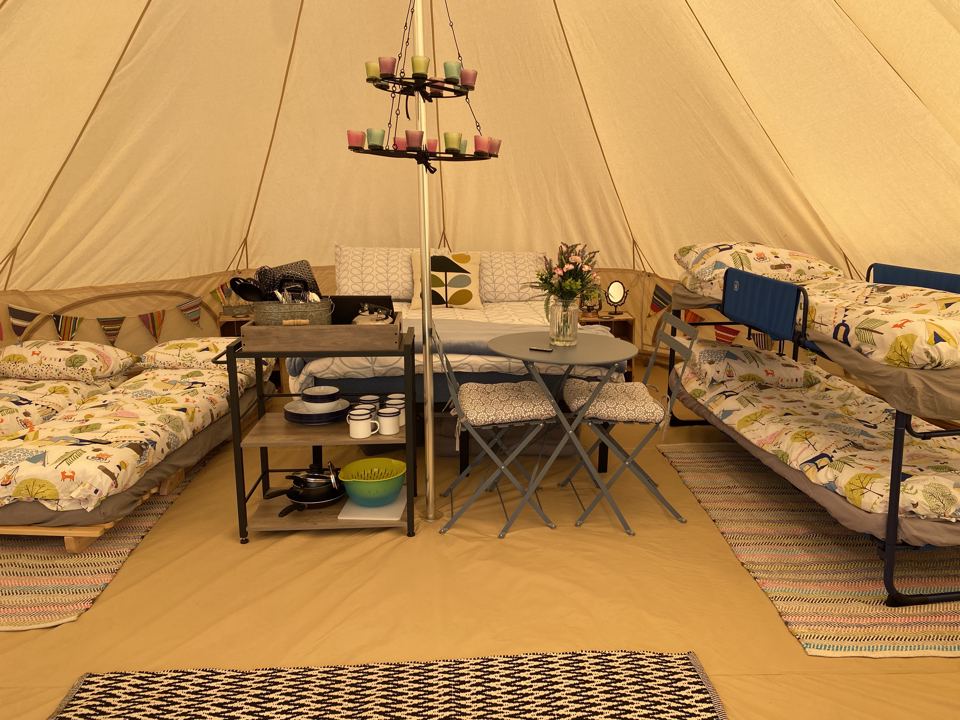 Beds and kitchen kit in a bell tent