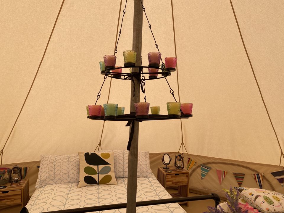 Chandelier and bed in a bell tent