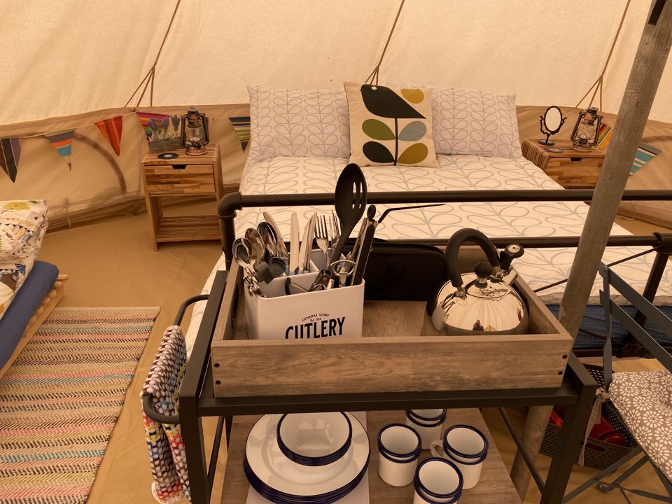 Bed and kitchen set in a bell tent