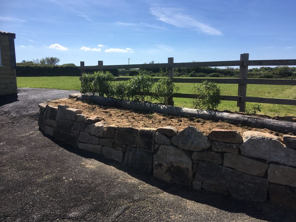 Stone planter with fields beyond