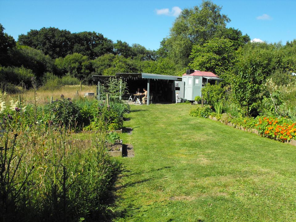 Small hut by the flower beds