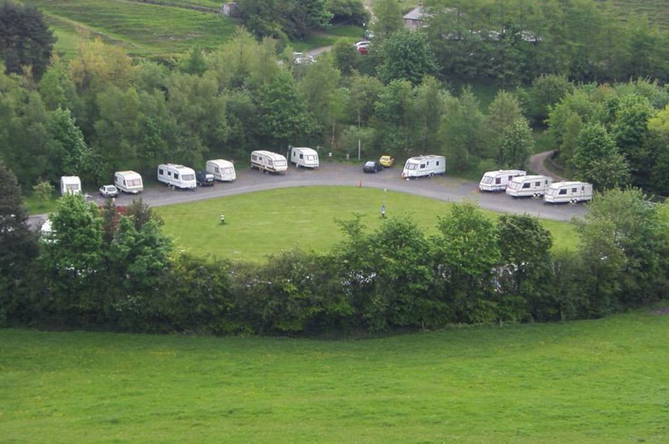 Site from above, vans around the green