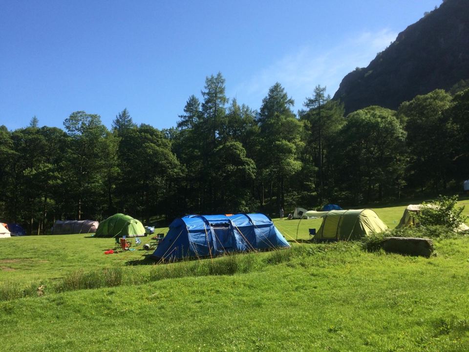 Tents pitched in the valley below the fells