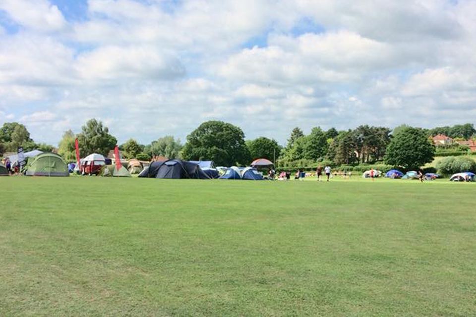 Open grass with tents