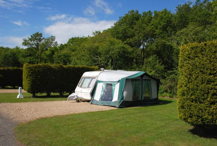 Caravan and awning by the hedge