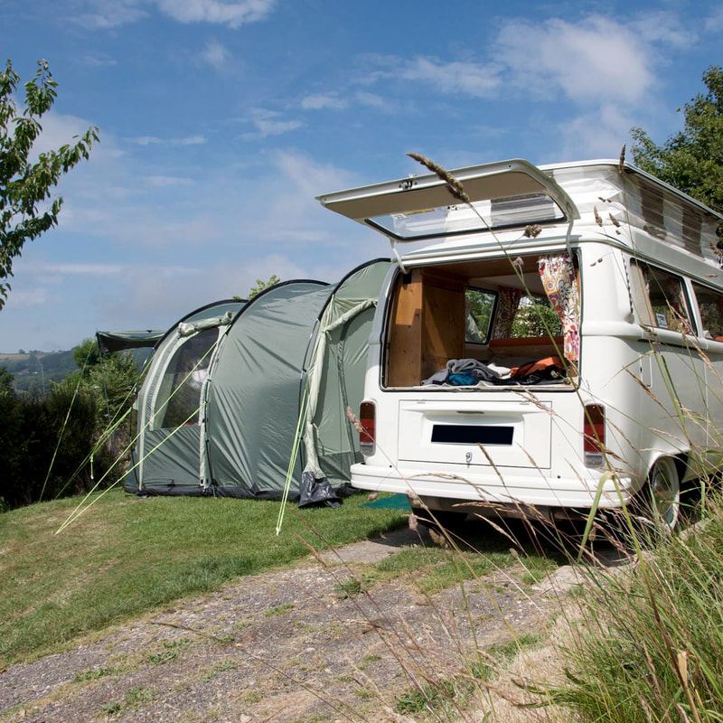 Campervan beside an awning tent