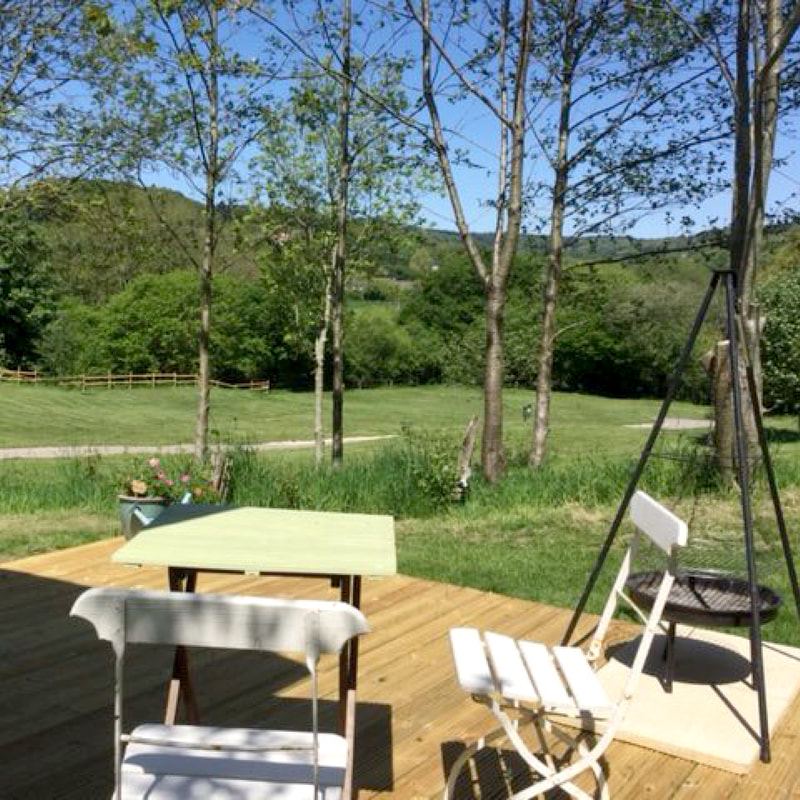 Decking with table among trees