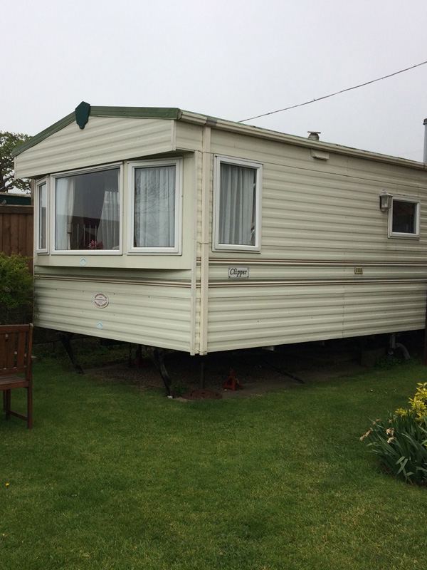 The static caravan on its lawn