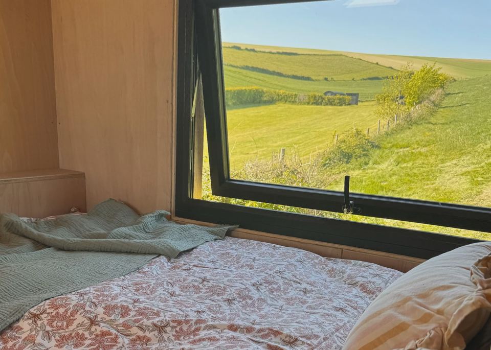 Bed by a hut window