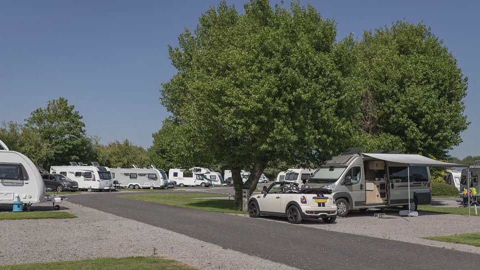 Pitches beside a wide road