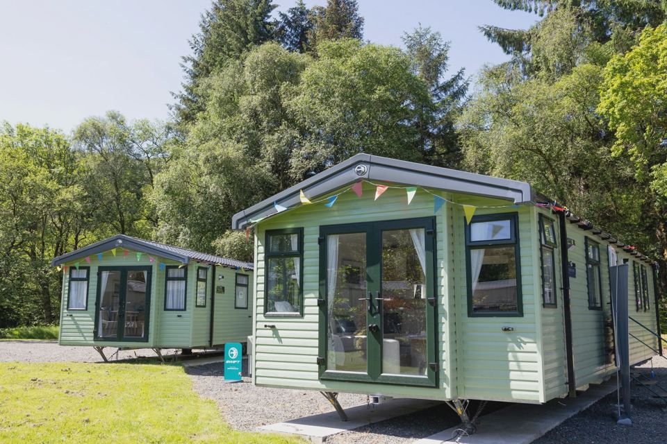 Static caravan among trees