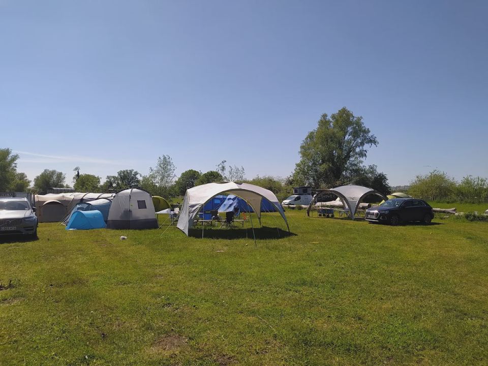 Tents spread across the meadow