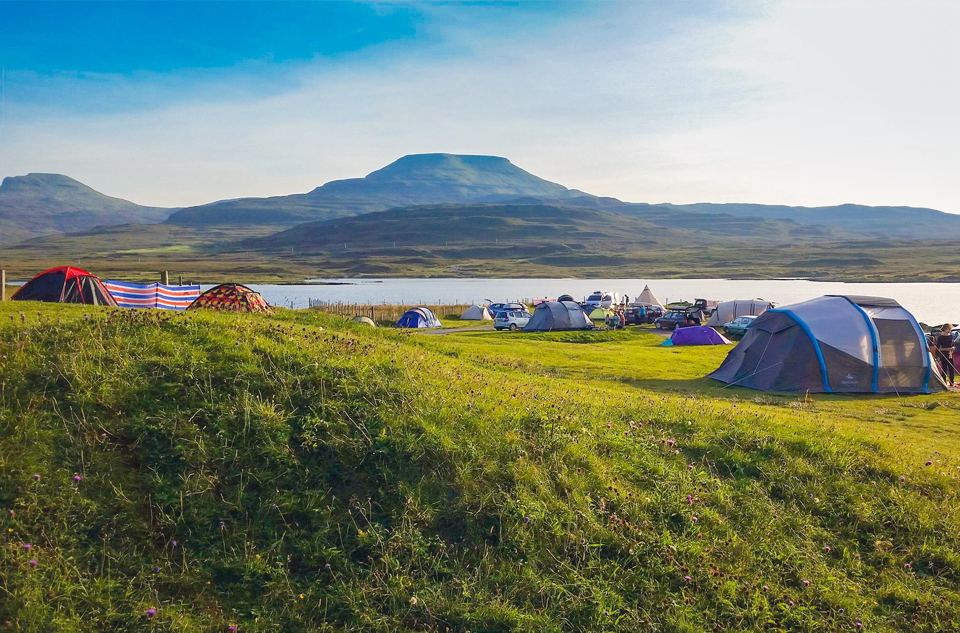Tent field with hills behind