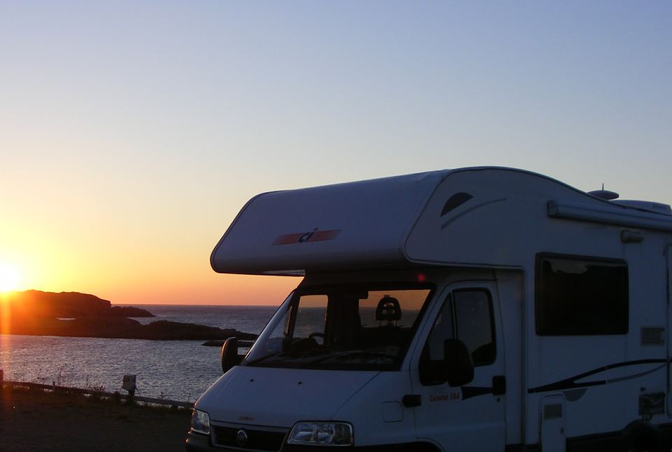 Motorhome at sunset by the water