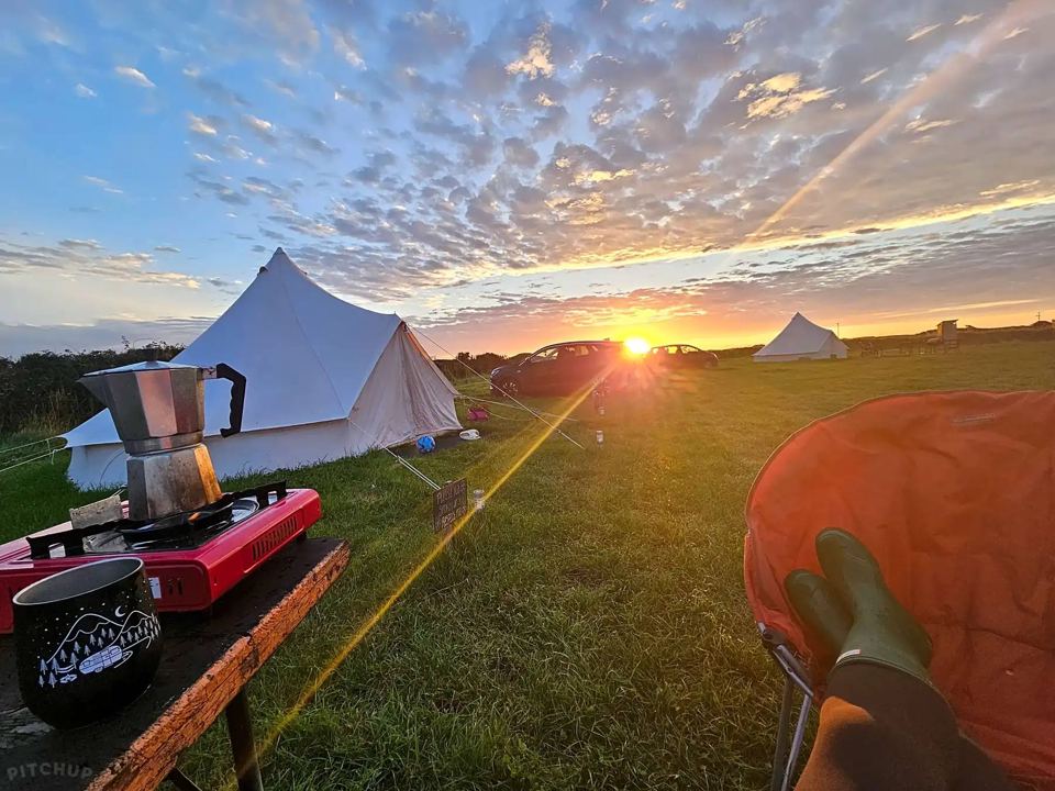 Bell tents at sunset with stove